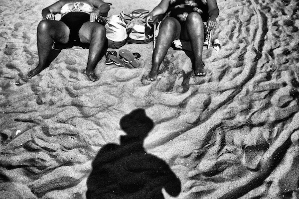 black and white image of people in sand