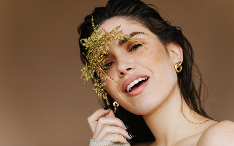 female model poses with an open smile