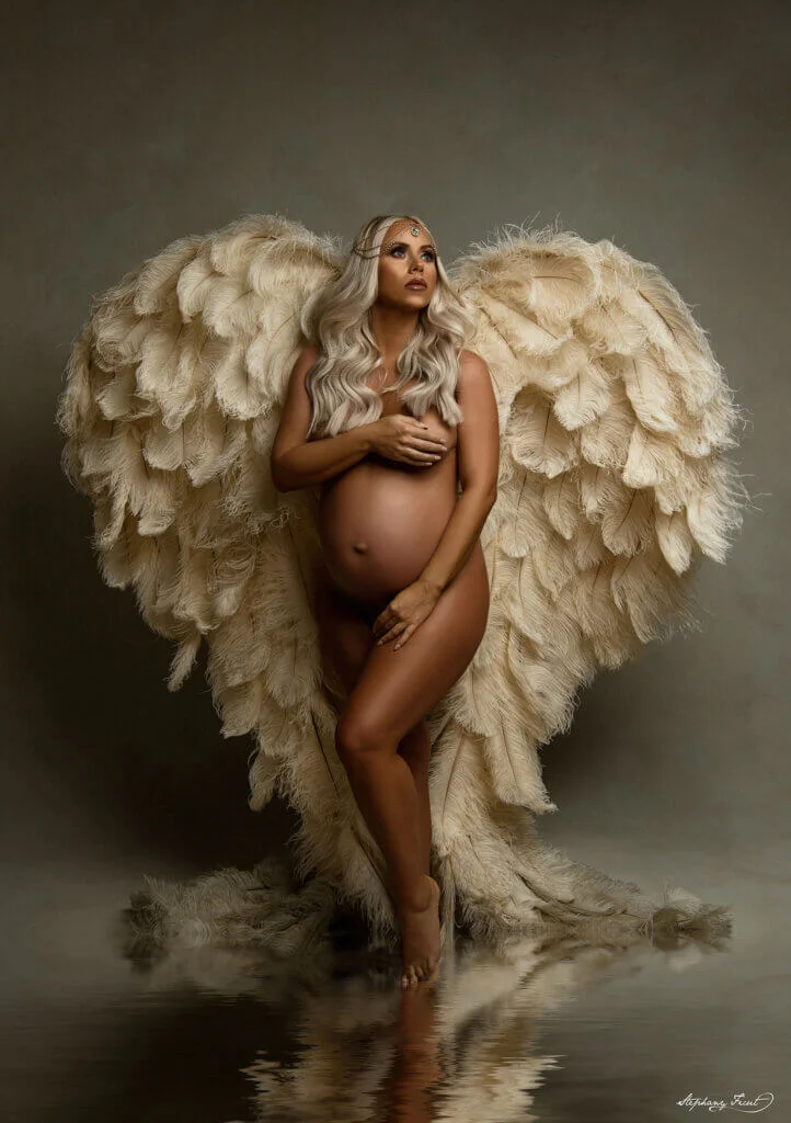 Maternity pose with gold wings