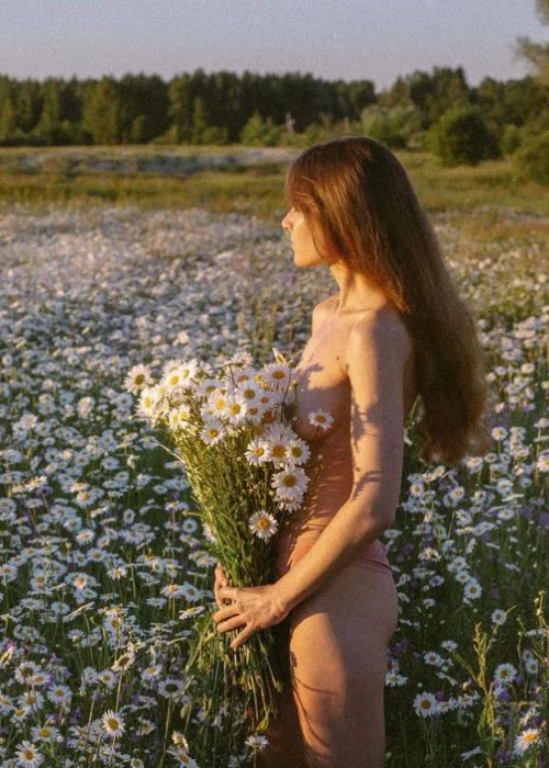 nude in nature women standing with flowers