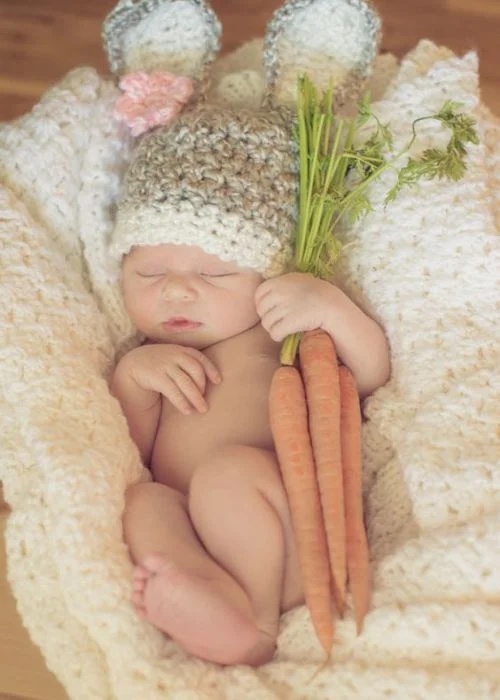 baby holding carrots, Easter baby photography, Easter-themed newborn photos, Easter newborn props