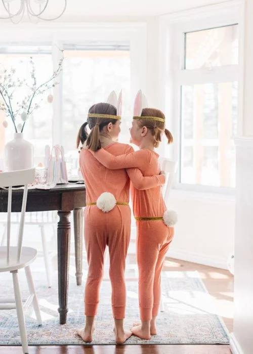 siblings wearing bunny tails and ears, creative Easter indoor photos wearing matching outfits